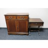 A Regency style double door cupboard and a drop leaf sofa occasional table