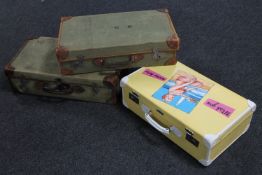 Two mid 20th century military style suitcases and another yellow painted suitcase with unique art