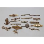 A good collection of seventeen gold brooches variously set with garnet, peridot, seed pearls,