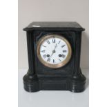 A Victorian slate mantel clock with enamel dial