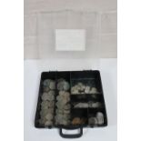 A plastic case containing a large quantity of pre-decimal silver three penny bits and other coins