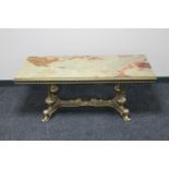 An ornate brass and onyx rectangular coffee table