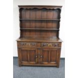 A carved oak double door Welsh dresser