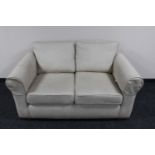 A two seater settee in beige fabric