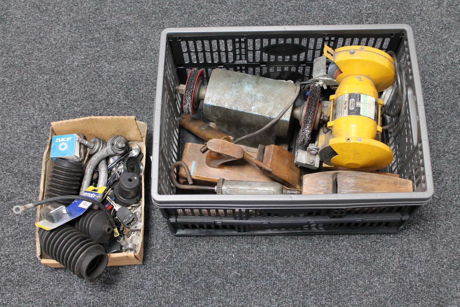 A crate of bench grinder, vintage wood working planes,