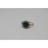 An 18ct gold sapphire and diamond cluster ring