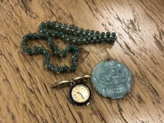A jade pendant, two bracelets and an enamel watch brooch.