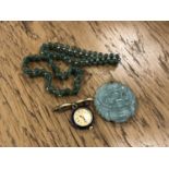 A jade pendant, two bracelets and an enamel watch brooch.