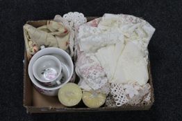 A box of lace table pieces, pair of candlesticks,