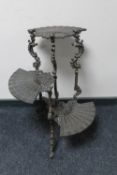 An ornate metal three tier oriental style plant stand