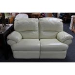 A two seater cream leather manual reclining settee