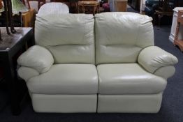 A two seater cream leather manual reclining settee