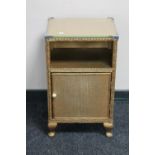 A gold rusty Lloyd Loom glass topped bedside cabinet