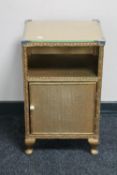 A gold rusty Lloyd Loom glass topped bedside cabinet