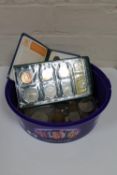 A plastic tub containing a quantity of British coins, pre decimal coins, Crowns,