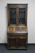 A carved oak bureau bookcase