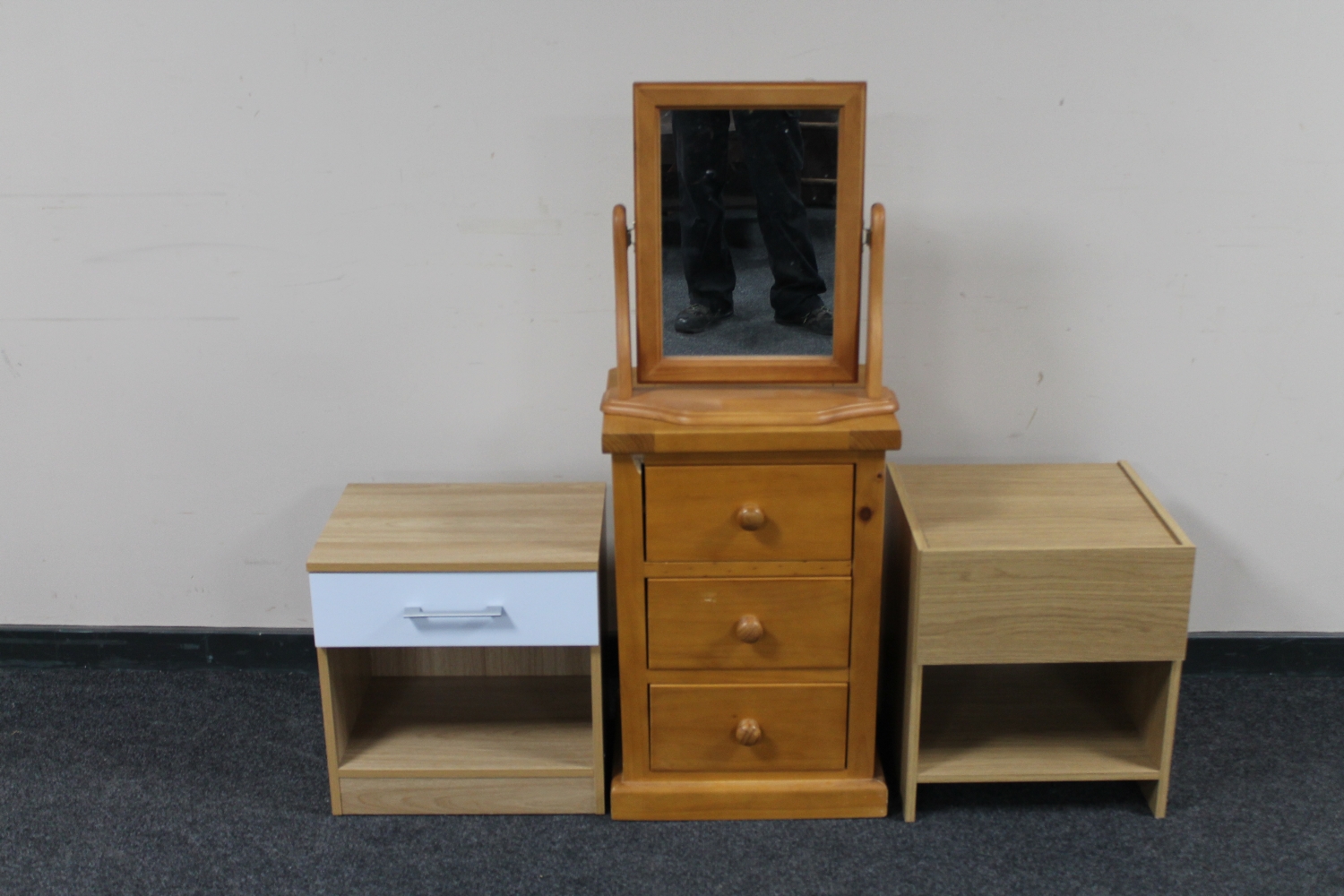 A pine three drawer bedside chest together with a dressing table mirror and two further bedside