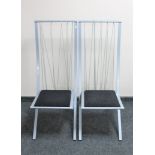 A pair of metal framed wire back dining chairs