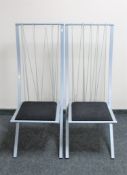 A pair of metal framed wire back dining chairs