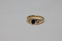 An 18ct gold diamond and sapphire three stone ring, size N CONDITION REPORT: 10.