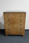A 1930's walnut five drawer chest