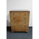 A 1930's walnut five drawer chest