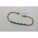 A 14ct gold emerald and diamond bracelet, length 17.