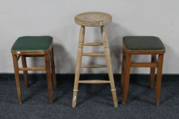 A pair of mid 20th century kitchen stools and a further pine stool