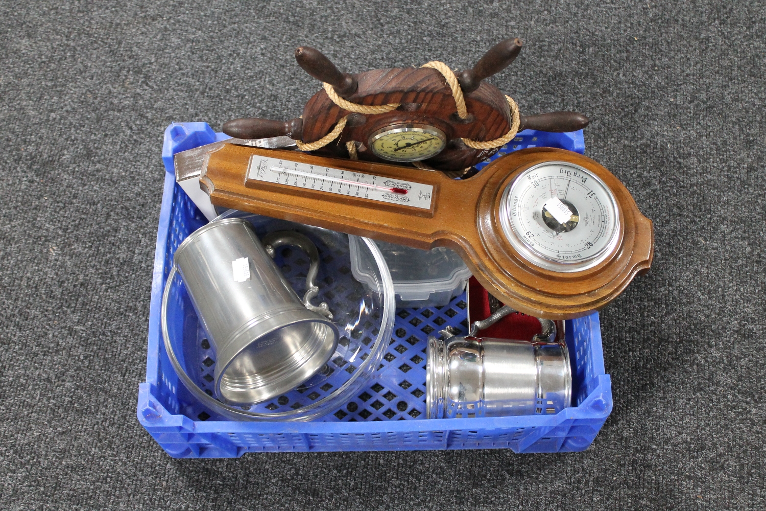 A basket of glass bowl, tankards, barometer,