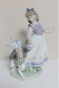 A Lladro figure - Alice CONDITION REPORT: In good condition with no apparent faults.