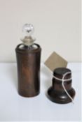 An antique treen lidded jar containing a glass chemist's bottle