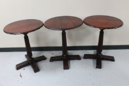 A set of six circular pedestal bar tables
