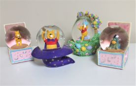 Four Disney snow globes : Winnie the Pooh and Friends