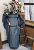 Three golf bags containing assorted irons and drivers