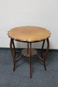A shaped Edwardian mahogany two tier occasional table