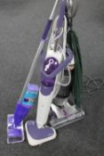 A Vax upright vacuum together with two floor mops