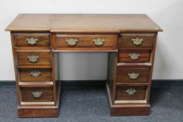 A Victorian mahogany breakfronted dressing table fitted with nine drawers