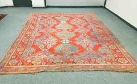 A large Persian woollen carpet on red ground, probably Ushak, central Anatolia,