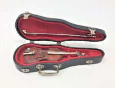 A continental silver mounted miniature violin, with silver bow in coffin case,