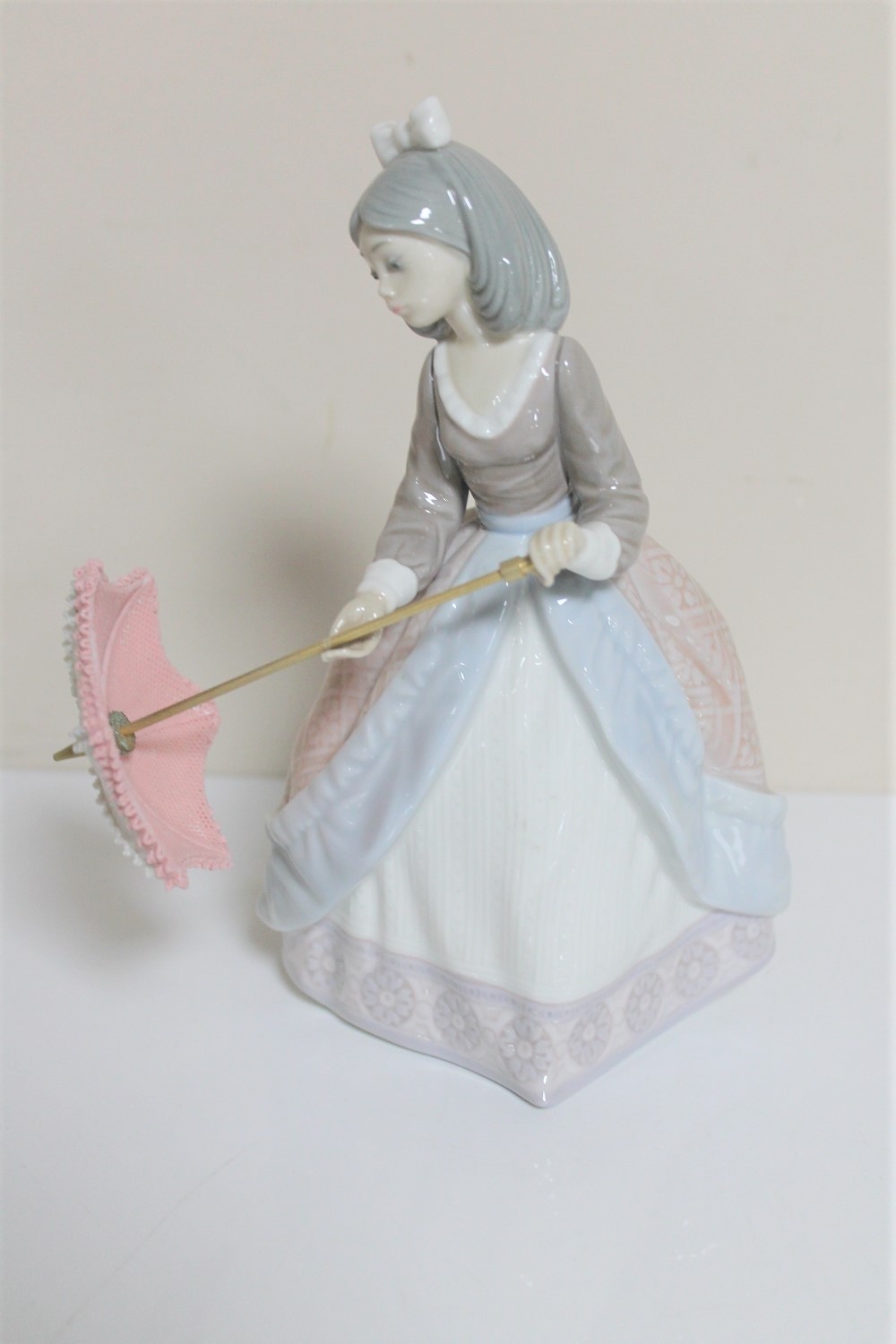A Lladro figure - Oriental figure with parasol