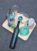 A tray of assorted antique and later glass ware to include a pewter oil lamp with blue glass