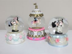 Three Disney snow globes : Mickey and Minnie Mouse