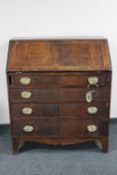 A George III inlaid mahogany bureau fitted with four drawers