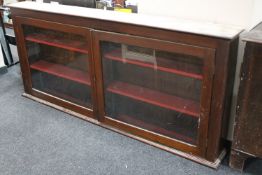 An antique mahogany glazed door wall cabinet fitted with shelves