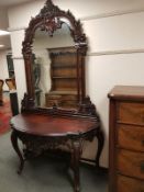 A heavily carved console table on cabriole legs with mirror back,