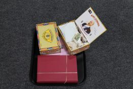 A tray containing an album of cigarette cards and two cigar boxes containing assorted cigarette