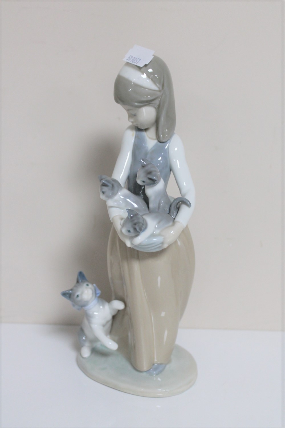 A Lladro figure - Girl with basket of puppies