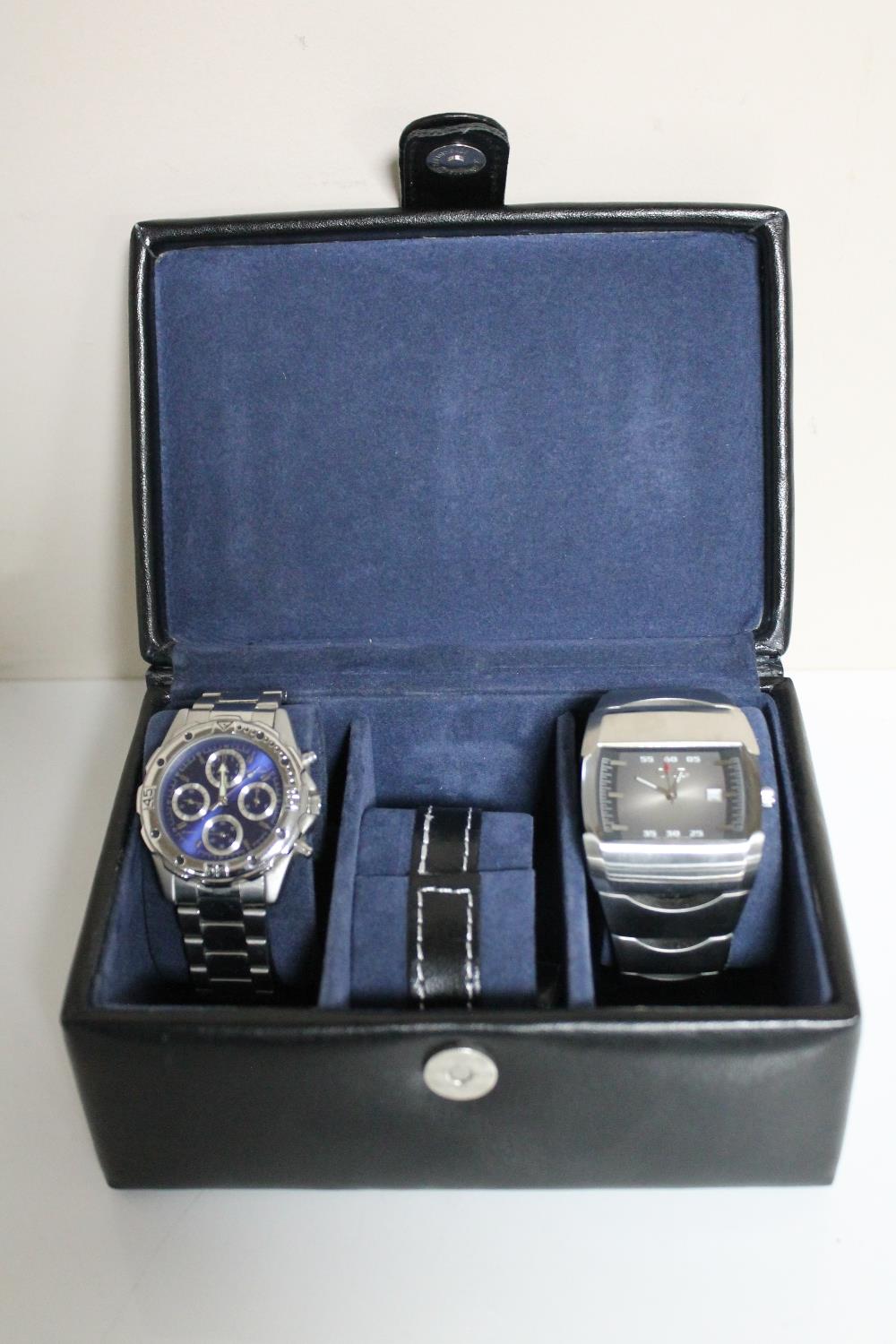 A leather box containing two gent's stainless steel Sekonda wristwatches