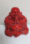 A glazed pottery figure of Buddha