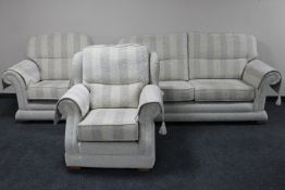 A contemporary three piece lounge suite upholstered in a striped fabric with arm covers *Purchased